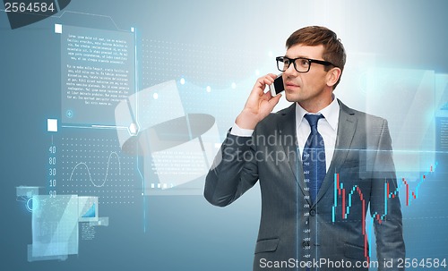 Image of buisnessman with cell phone and forex chart