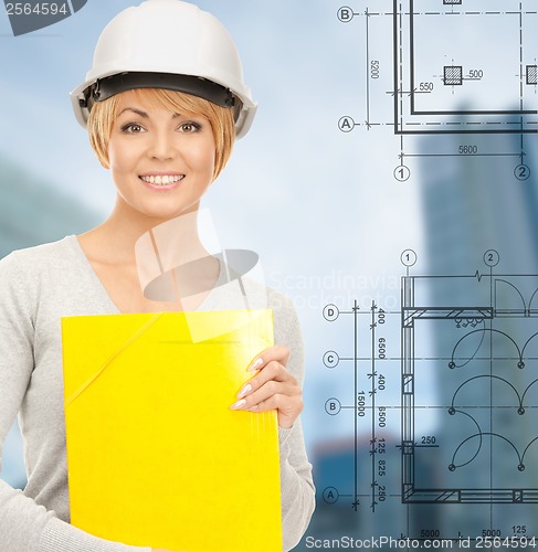 Image of female contractor in white helmet with files