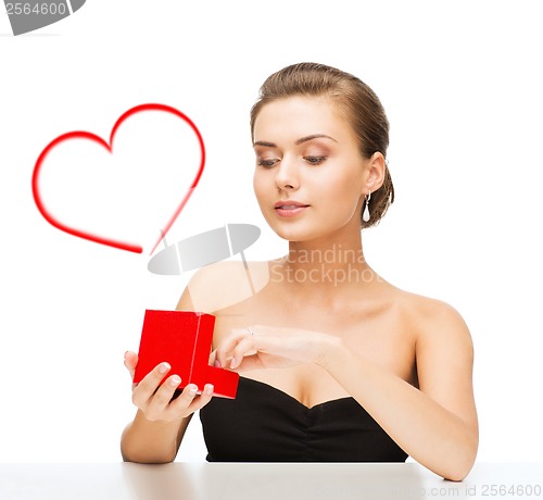Image of woman with diamond earrings and gift box