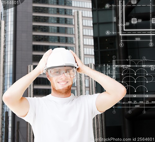 Image of male architect in white helmet with safety glasses