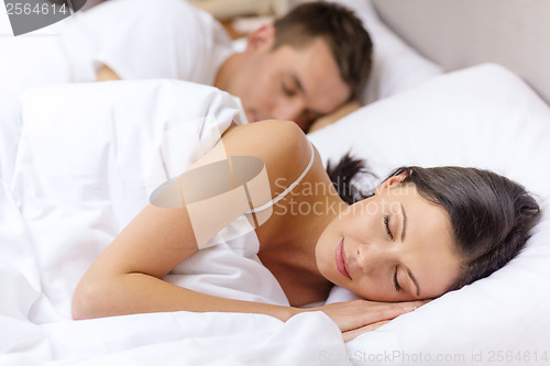 Image of happy couple sleeping in bed
