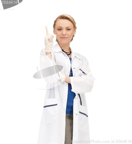 Image of smiling female doctor pointing her finger up