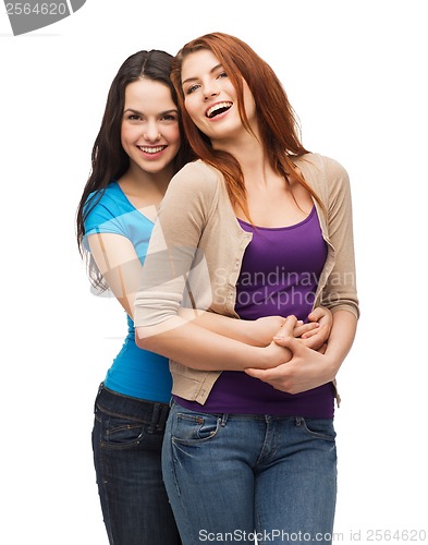 Image of two laughing girls hugging