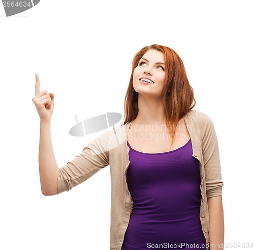 Image of smiling teenager pointing her finger up