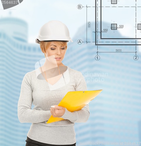 Image of female contractor in white helmet with files