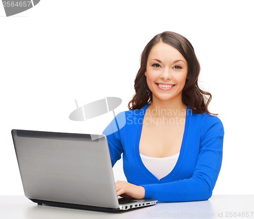 Image of smiling woman in blue clothes with laptop computer