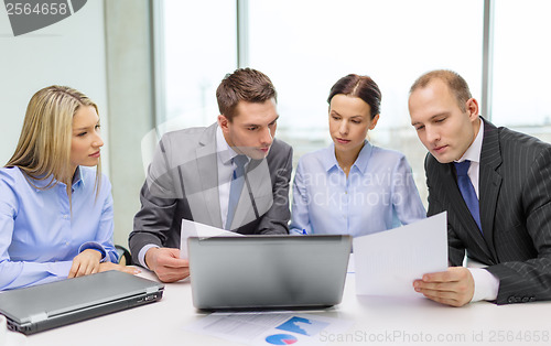 Image of business team with laptop having discussion