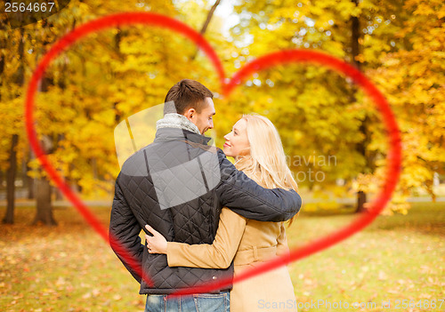 Image of romantic couple kissing in the autumn park