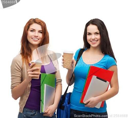 Image of two students with bag, folders, tablet and coffee