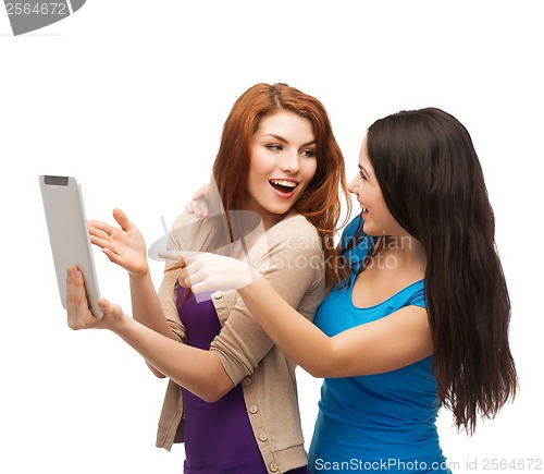 Image of two smiling teenages with tablet pc computer