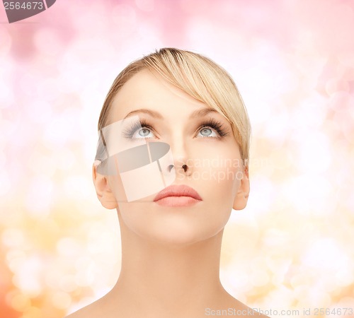 Image of beautiful woman looking up
