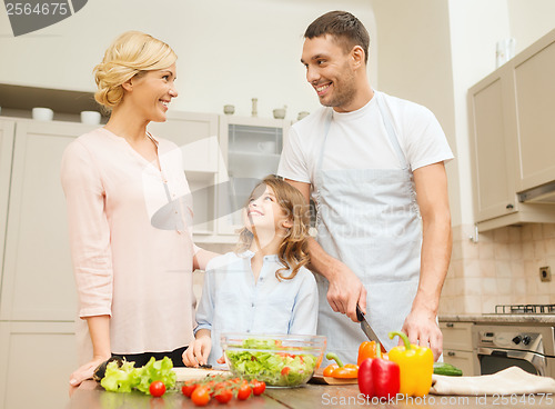 Image of happy family making dinner in kitchen