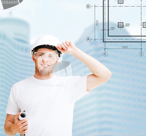 Image of male architect in white helmet with blueprint