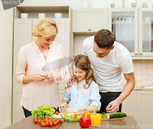 Image of happy family making dinner in kitchen