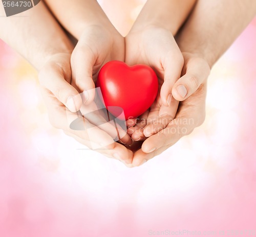 Image of woman and man hands with heart