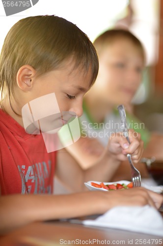 Image of Little boy eating at home
