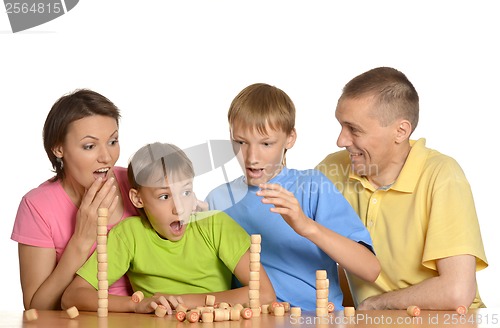 Image of Happy family playing at table