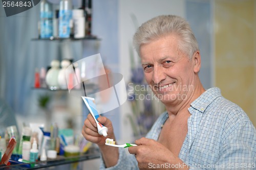 Image of Old guy brushing teeth