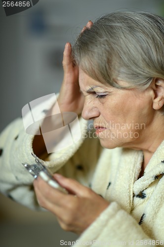 Image of Senior  woman with pills