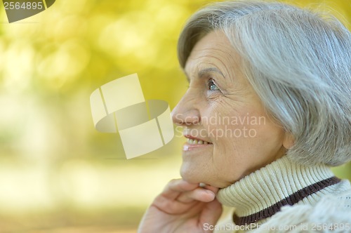 Image of Thoughtful senior woman in autumn