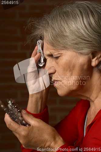 Image of Older sick woman in red