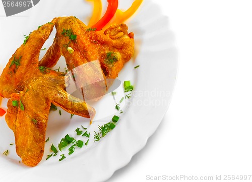 Image of Fried chicken wings with legs his chopped pepper, onion and fenn
