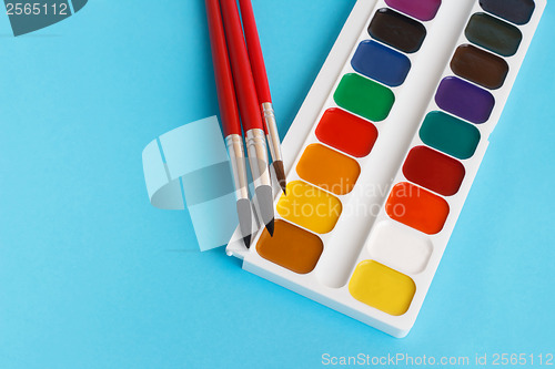 Image of brushes for watercolors paints for children on blue background