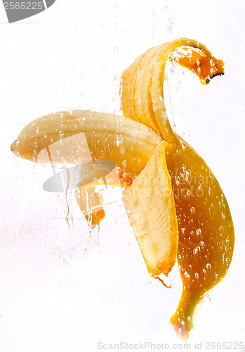 Image of open banana on a white background with water drops