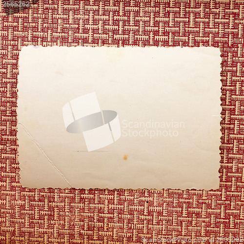 Image of piece of old paper lying on a brown texture background