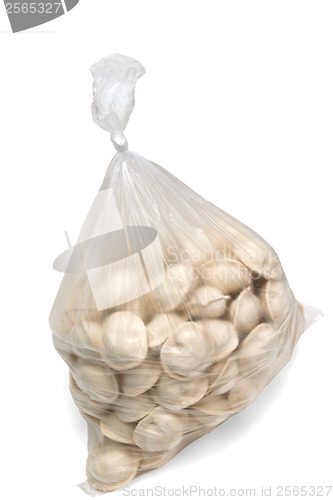 Image of raw dumplings in a plastic cellophane bag isolated on white back