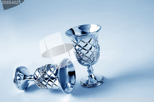 Image of old silver goblet on a blue background