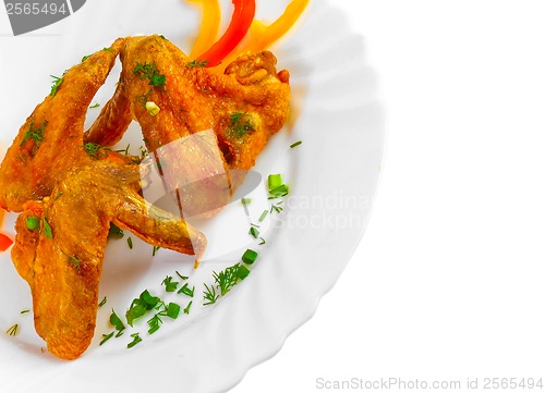 Image of Fried chicken wings with legs his chopped pepper, onion and fenn