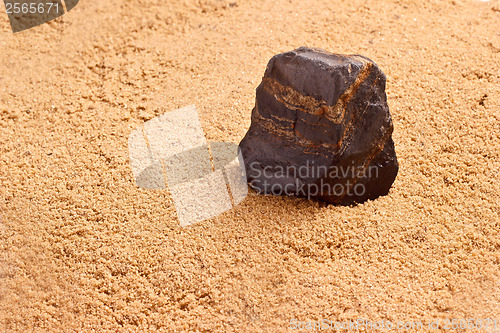 Image of stone in the sand texture