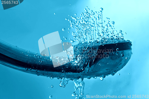 Image of fresh shower and drops and sprays water on a blue background tex
