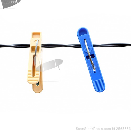 Image of clothespins on a rope on a white background