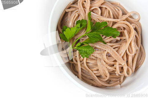Image of dark pasta in a bowl isolated a on white background