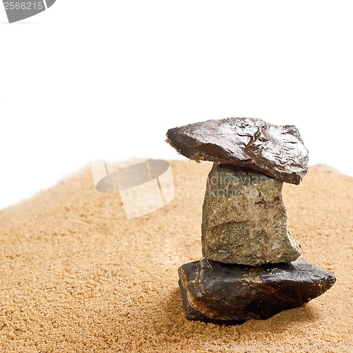 Image of cairn in the sand is isolated