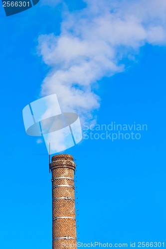 Image of ecology pipe and smoke against the blue sky
