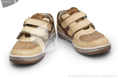Image of old children beige shoes with Velcro sneakers isolated on white 
