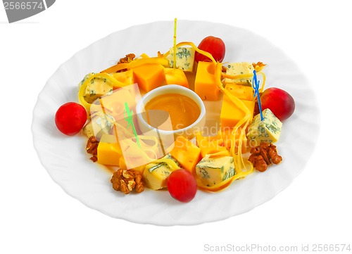 Image of Different types of cheese appetizer with honey, nuts and grapes