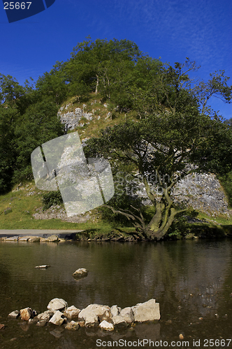 Image of View of a rocky hill with river in foreground