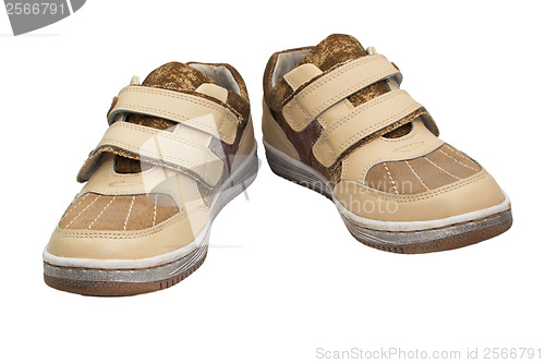 Image of old children beige shoes with Velcro sneakers isolated on white 