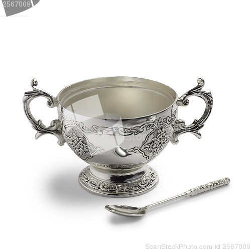 Image of antique silver cup and spoon with a drop shadow