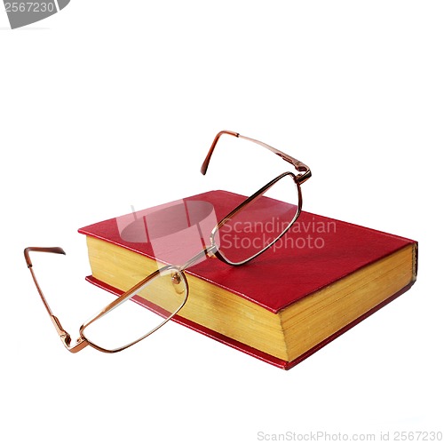 Image of glasses and a red book isolated on white background