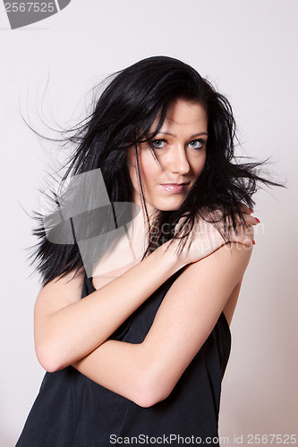 Image of A woman in a black undershirt with tousled hair