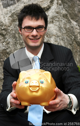 Image of Businessman and piggy bank.