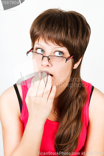 Image of Young attractive girl with glasses surprised