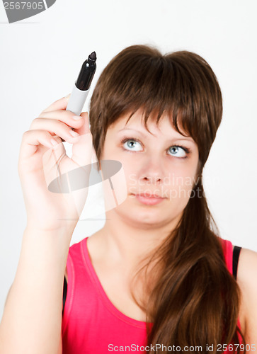 Image of Young girl writing with a black marker