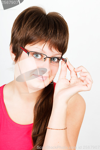 Image of Young attractive blue-eyed girl in glasses