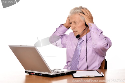 Image of Elderly businessman with laptop